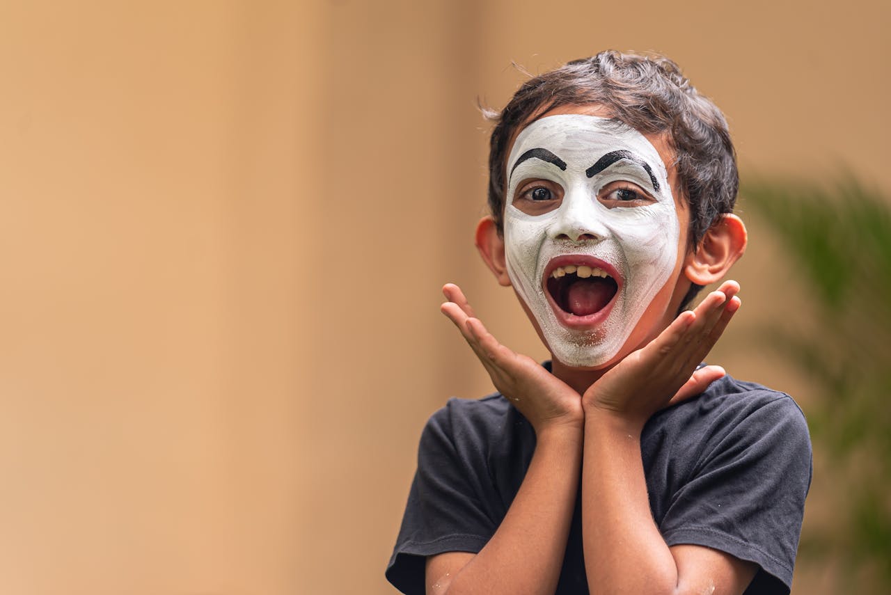 excited-child-with-face-paint-expressing-joy-30642813